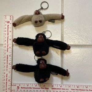 Three Kipling handbag monkey keychains